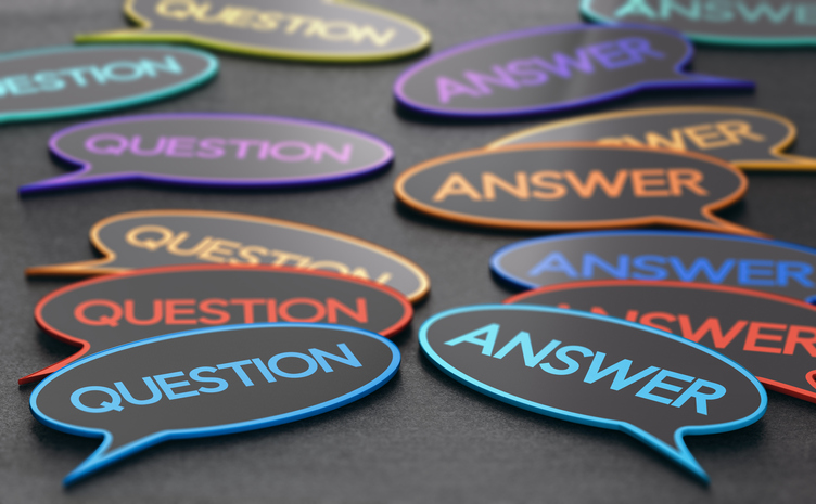 Piles of stickers of different colors that say "question" and "answer' on them.